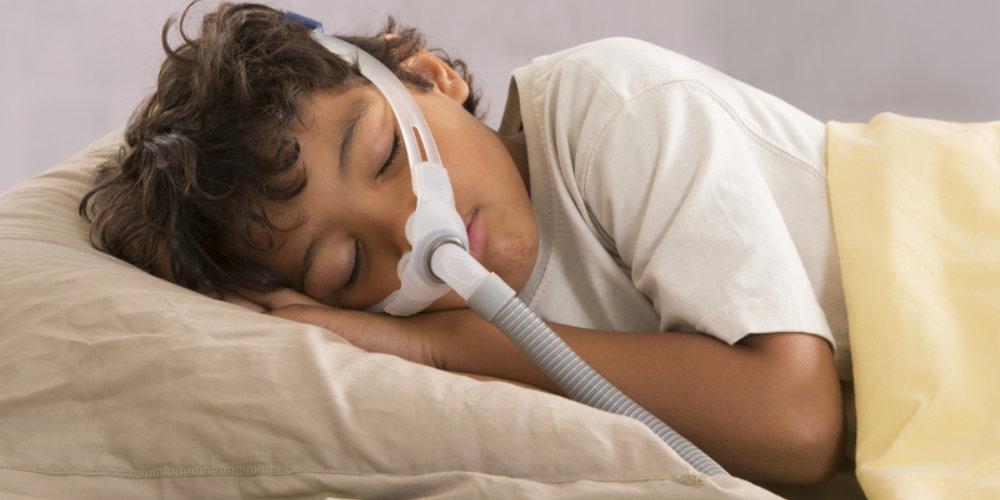 Child sleeping with PAP mask on.